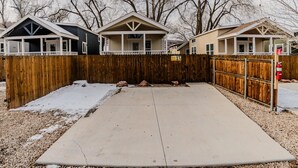 Il s’agit d’un quartier résidentiel composé de trois maisons de plain-pied, chacune dotée d’un porche et d’une clôture en bois. Une allée en béton mène aux maisons, et il y a une borne d’incendie sur le côté droit.
