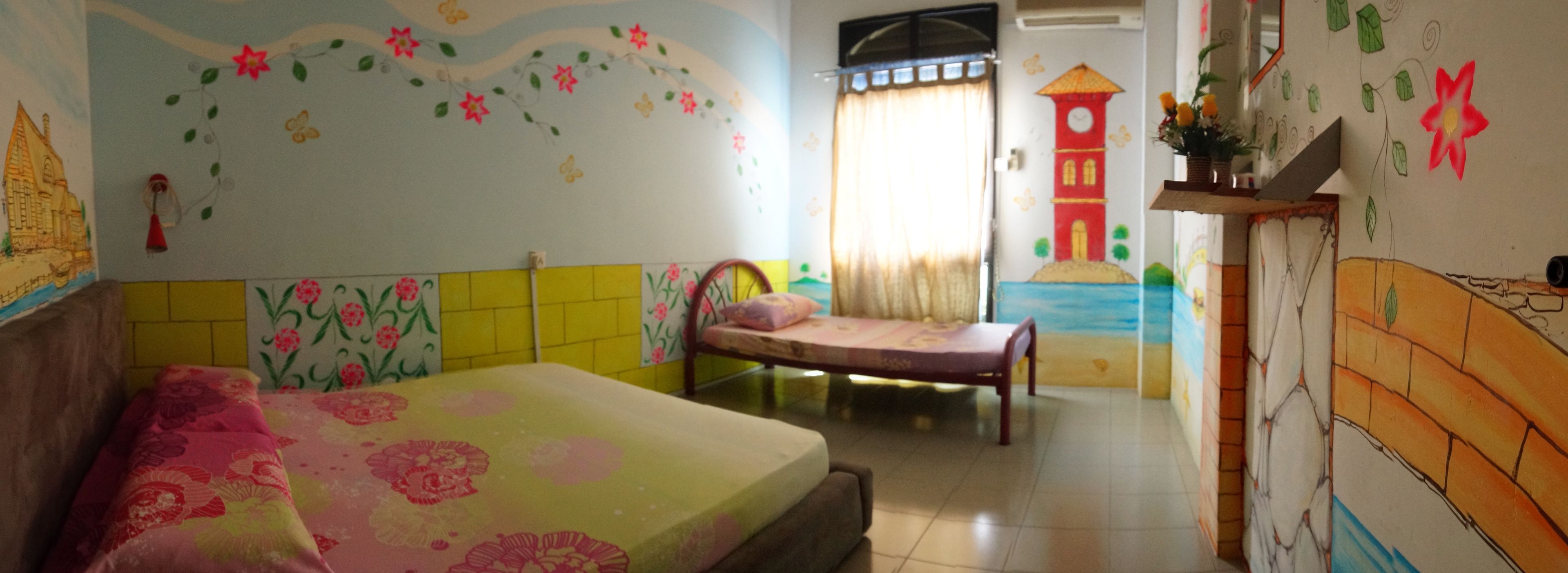 A bedroom with a bed, a bedside table, and a window with curtains.