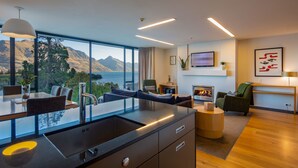 A modern kitchen with a large window overlooking a scenic mountain view. - Panorama Terrace Apartments, Element Escapes (Queenstown)
