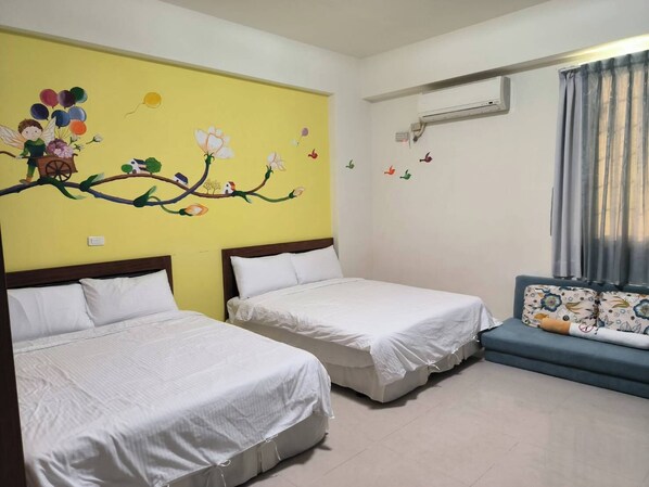 A hotel room with two single beds, a sofa, a wall mural, and an air conditioning unit. - Vineyard Guest House (Taitung)