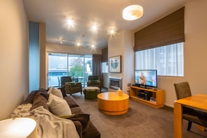 Relax in this stylish living room with a comfortable sofa, coffee table, and fireplace.