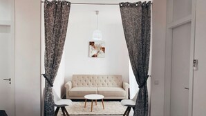 A modern living room with a beige sofa, two white chairs, a round coffee table, and a white rug. - ALICANTE CENTER APART THE PENTHOUSE WITH TERRACE (Alicante (Alacant))