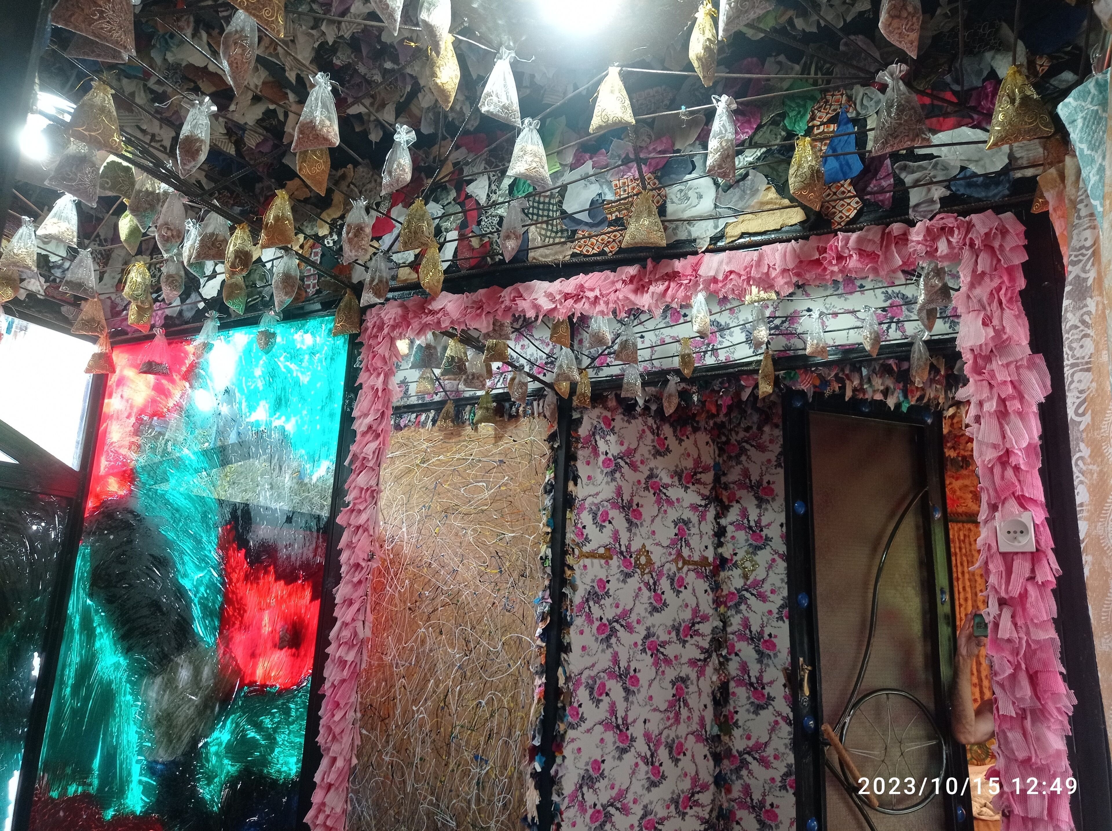 A room with a patterned wall, a door, and a window.