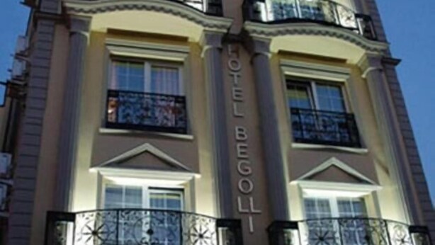 A multi-story hotel with balconies, a prominent 'HOTEL BEGOLI' sign, and a classic architectural style. - Hotel Begolli (Pristina)