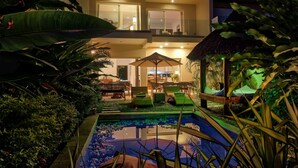A two-story building with a pool, outdoor seating, and tropical plants. - Bel Horizon (Nosy Be)