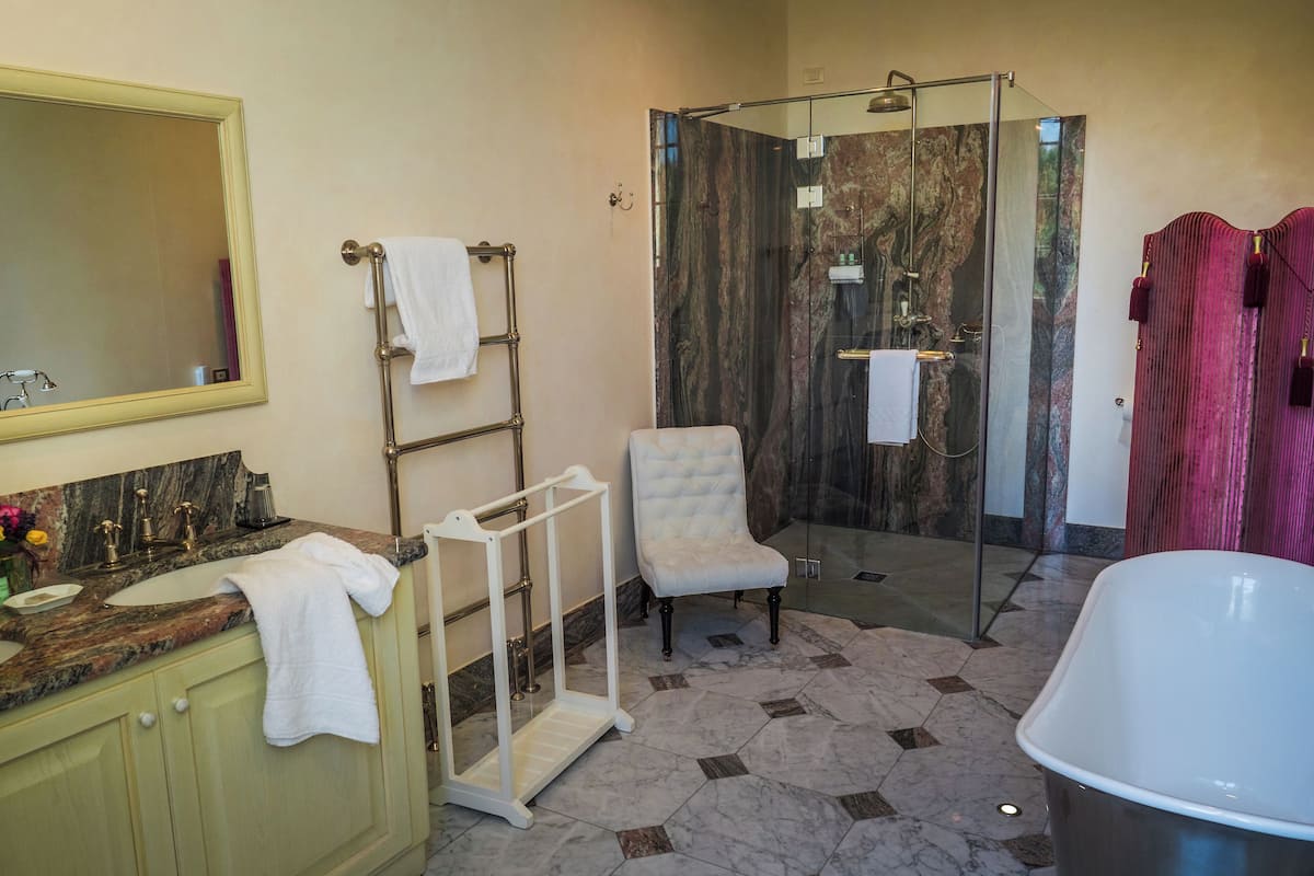superior suite, balcony, valley view | bathroom | combined shower/bathtub, deep-soaking bathtub, rainfall showerhead