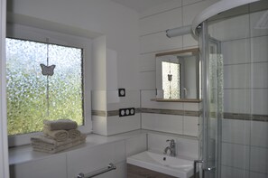Shower, hair dryer, towels, toilet paper