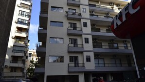 A multi-story residential building with balconies, air conditioning units, and a KFC sign. - Achrafieh 219 (Beirut)