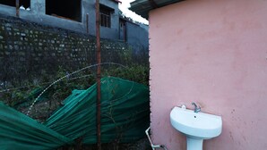 A pink building with a white sink and a window. - OYO 26673 The Royal Rishikesh - Campsite (Rishikesh)