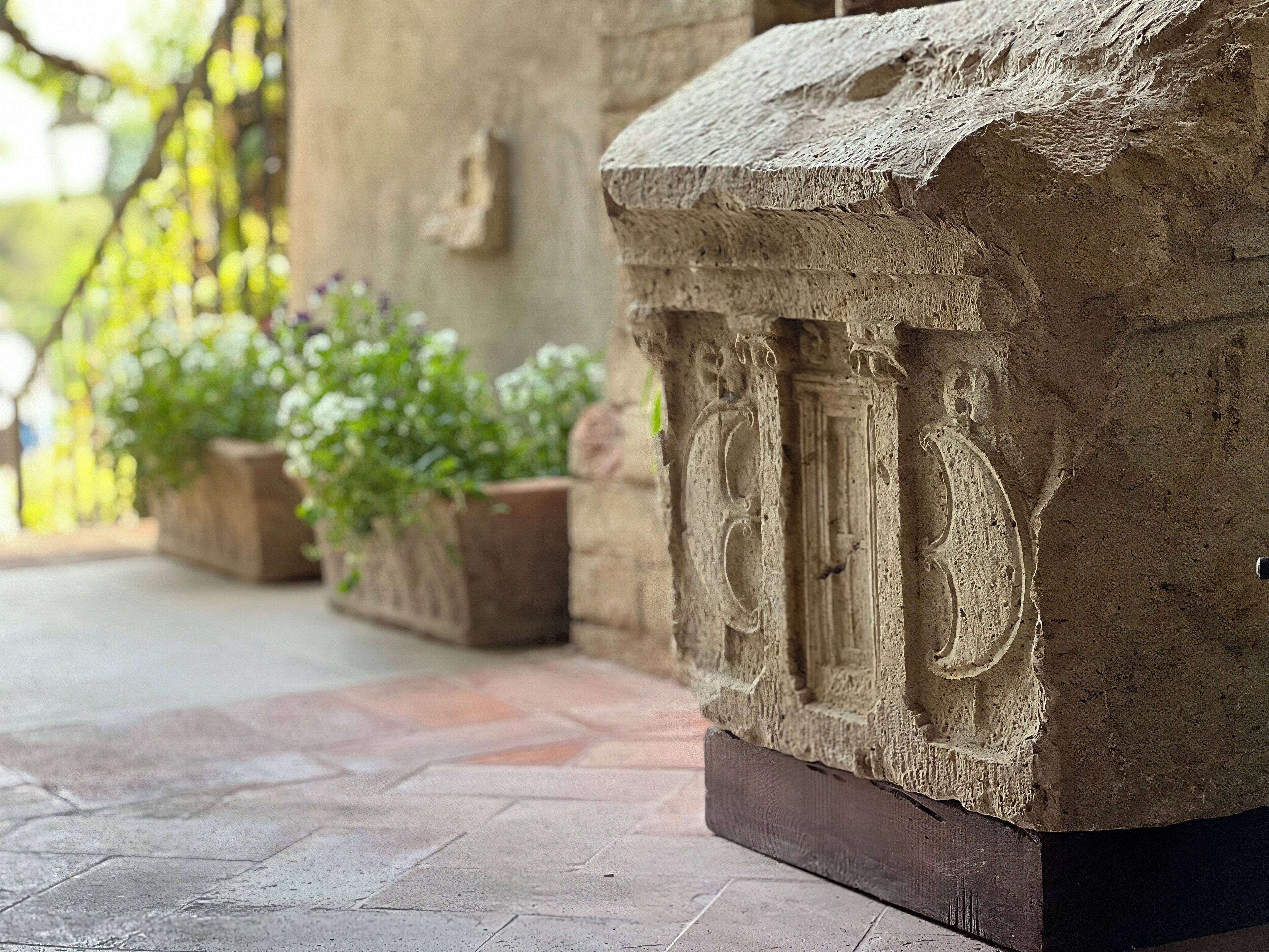 A stone structure with carved columns, possibly a part of a historical building or monument.