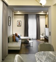 A modern living room with a sofa, a coffee table, and a TV.