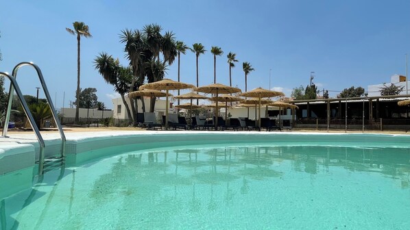 Seasonal outdoor pool, pool umbrellas, pool loungers