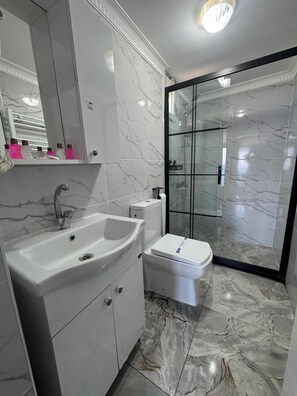 Shower, hair dryer, slippers, towels