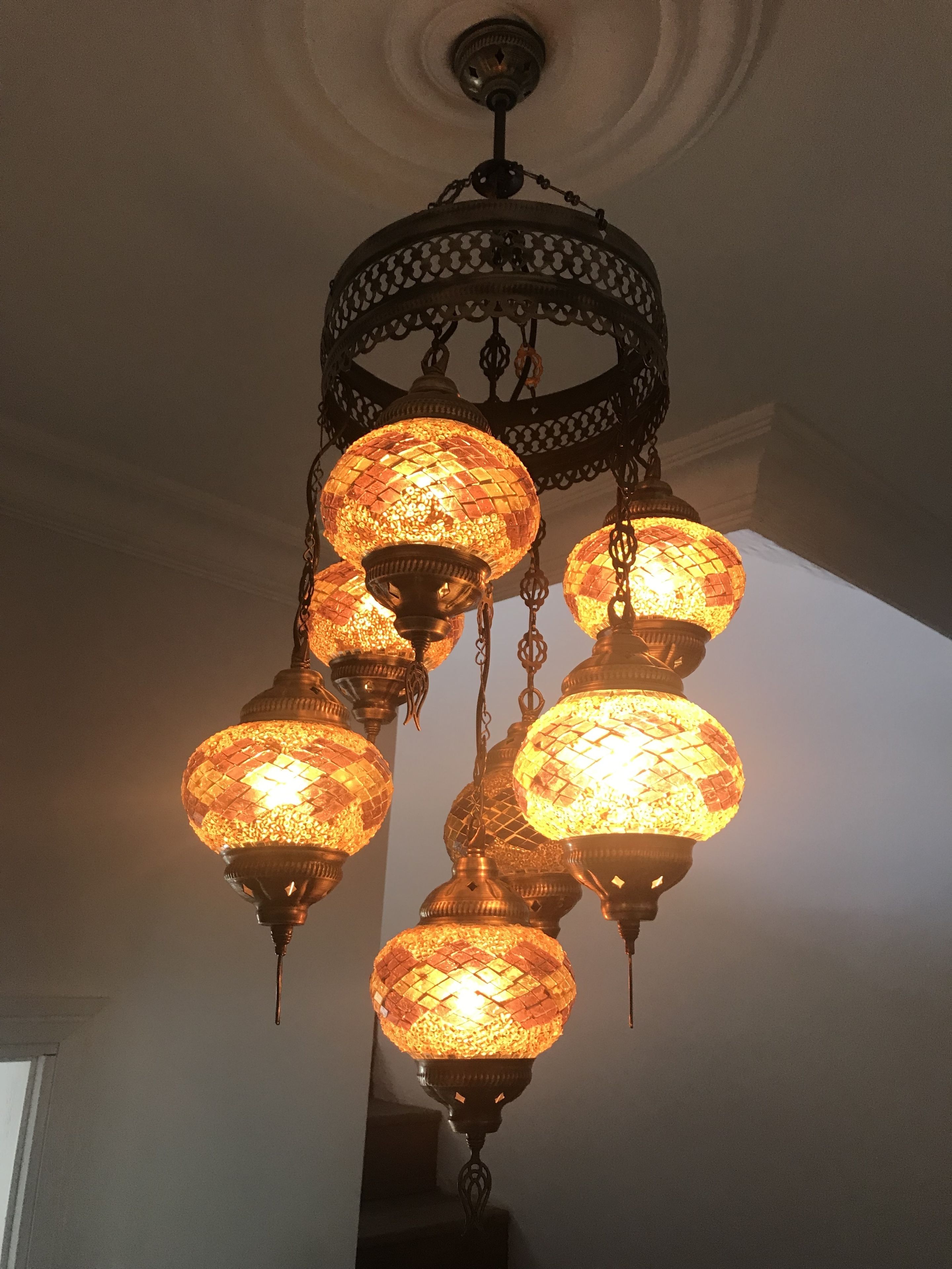 A chandelier with multiple spherical glass lampshades.