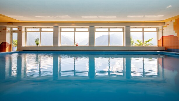 A large indoor swimming pool with clear windows and a view of mountains. - Holidays - in the midst of nature - hiking in the countryside - mountain retreat (SCHLUDERNS)