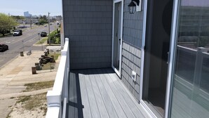 A balcony with a view of a street and a cityscape. - Ocean Views, Watch the breakers from the Deck; B side (Brigantine)