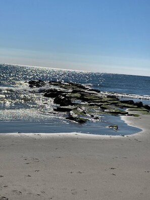 Enjoy the serene ocean views and gentle waves lapping against the rocky shoreline.