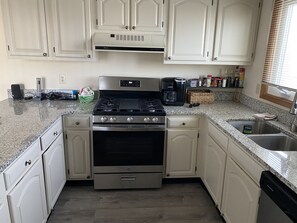 Enjoy cooking in this well-equipped kitchen with a stainless steel range, oven, and dishwasher.