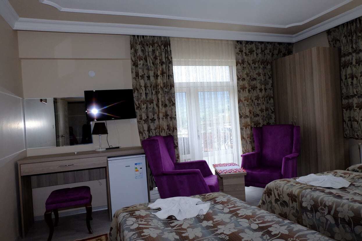 standard triple room | living area | lcd tv