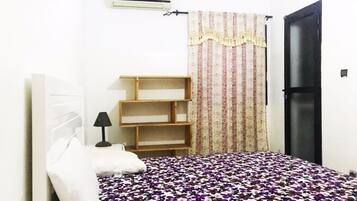 Apartment, 2 Bedrooms | Desk, blackout curtains, iron/ironing board, cots/infant beds