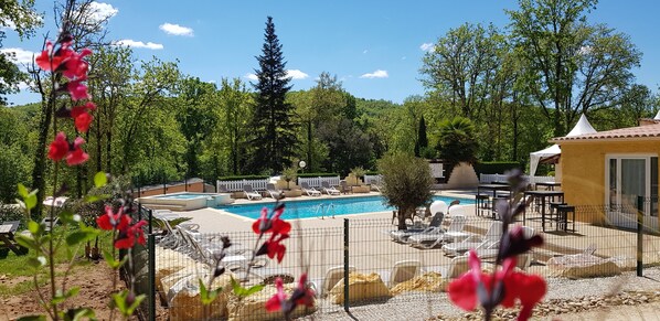 Seasonal outdoor pool, open 10:00 AM to 8:00 PM, pool umbrellas