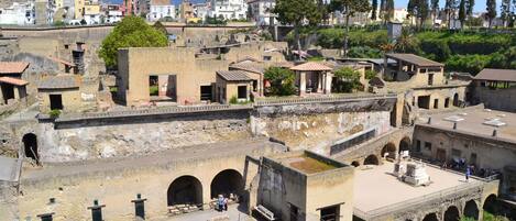 An archaeological site with ruins, including arches and a courtyard.