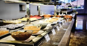A buffet with various food options and labeled containers.