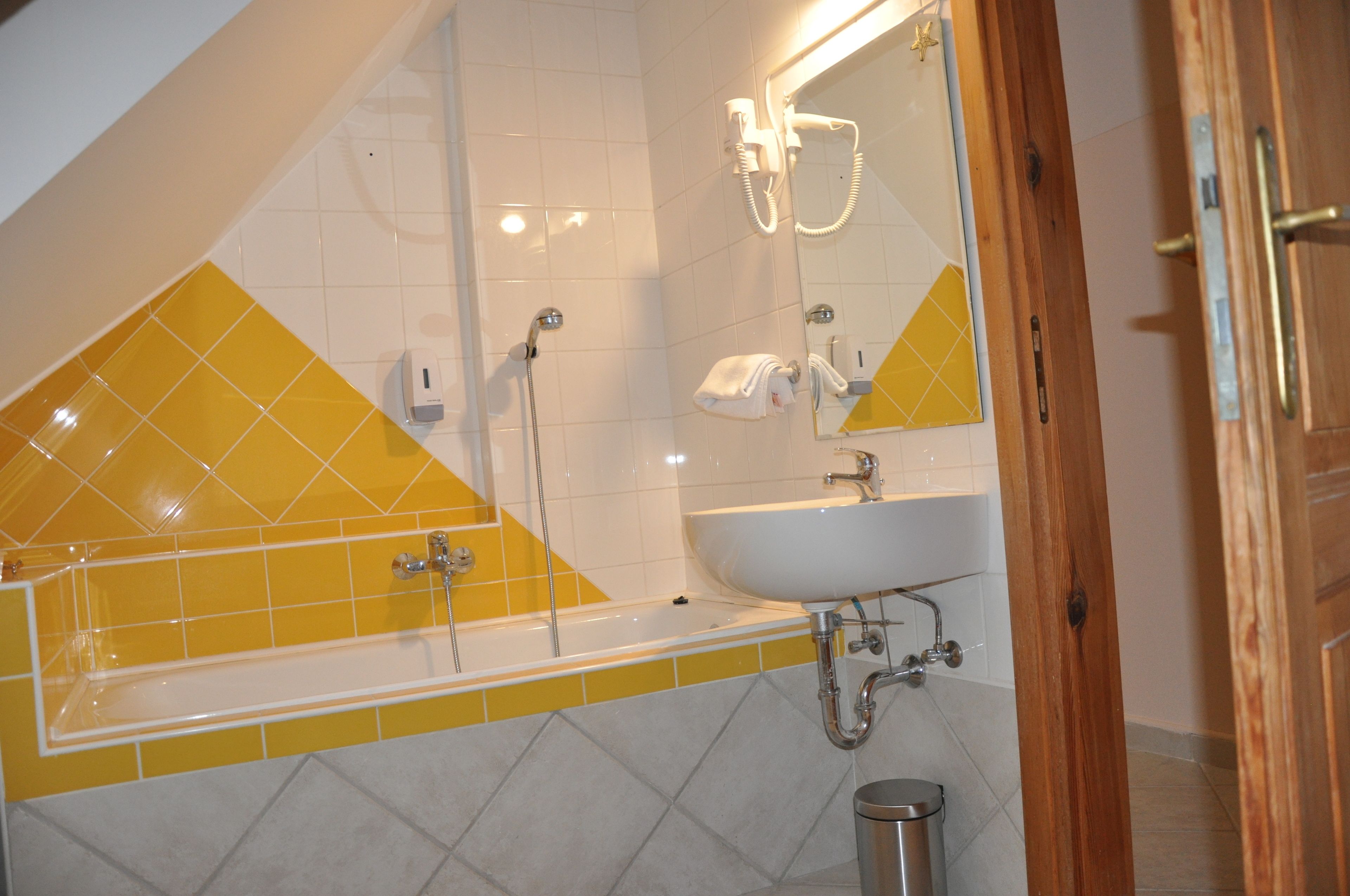 A bathroom with a bathtub, a sink, and a shower.