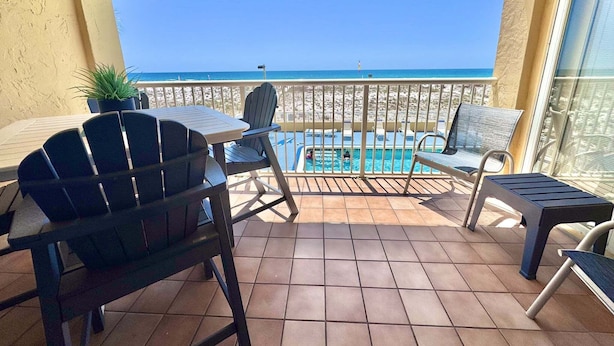 A balcony with a pool, chairs, and a view of the beach. - Relax and Catch a couple fish! 🎣 ~ There is something for everyone! (Gulf Shores)