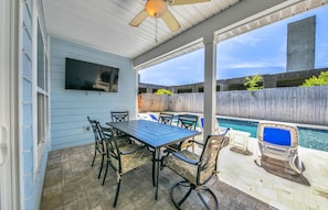 Enjoy dining al fresco with a view of the swimming pool from this outdoor patio.