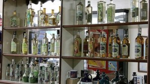 A liquor cabinet with multiple shelves filled with bottles of various liquors. - Xikus Palace Hotel (Guanhaes)