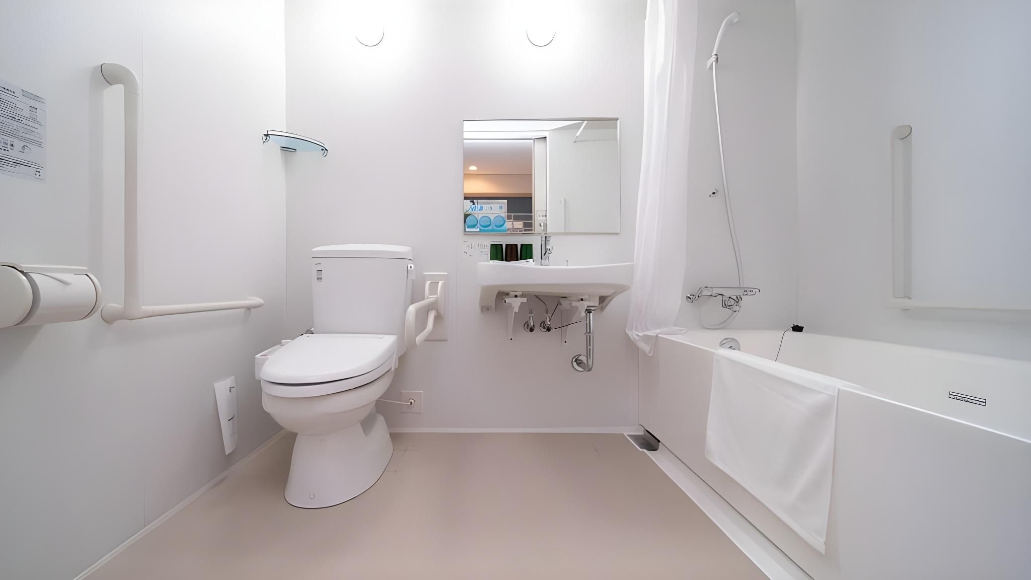 A modern bathroom with a toilet, sink, and bathtub.