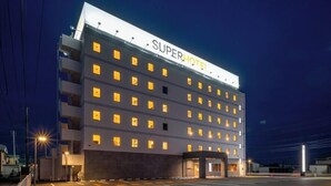 A SuperHotel with multiple floors, a large entrance, and a well-lit facade. - Super Hotel Yamagata Tsuruoka (Tsuruoka)