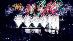 A nighttime view of a waterfront with fireworks display. - Hotel Showa Club (Atami)