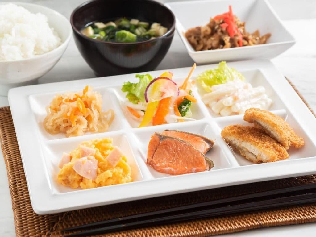 A meal with various dishes including rice, soup, salad, and seafood.