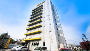 A multi-story hotel with a modern design, featuring balconies on several floors and a clear blue sky in the background. - Super Hotel Hachinohe Natural Hot Springs (Hachinohe)