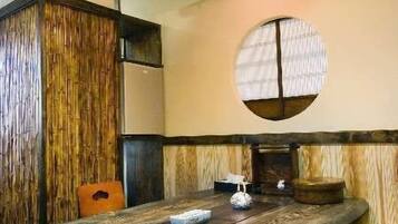 A traditional Japanese-style room with tatami flooring, a low table, and a shoji screen.