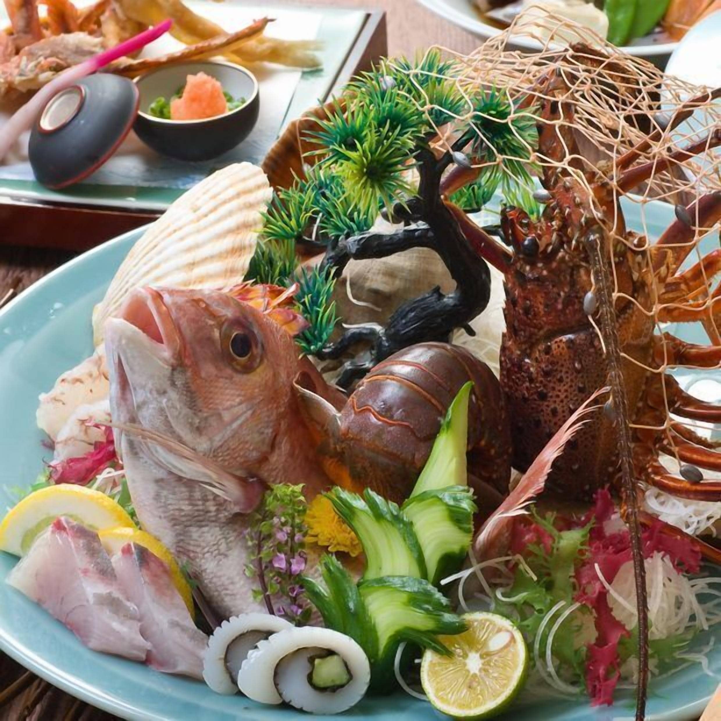 A seafood platter with various items including fish, lobster, and vegetables.