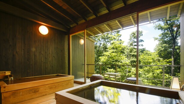 A wooden spa area with a hot tub and wooden benches, large windows offering a view of lush greenery. - Spa Terrace Shisui (Kobe)