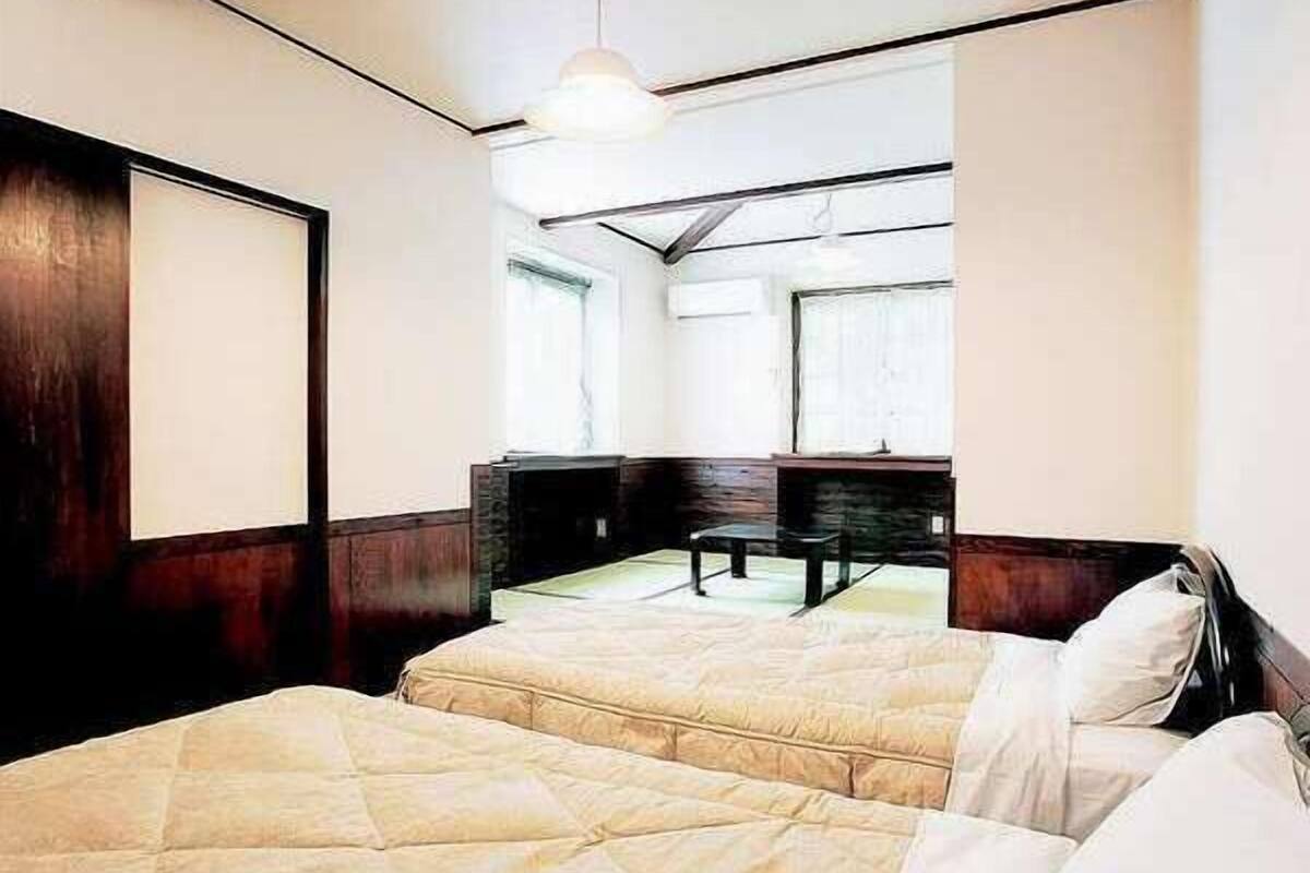 A bedroom with a bed, a dresser, and a mirror.