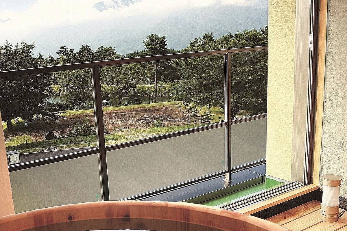 A hot tub with a view of a road and trees.