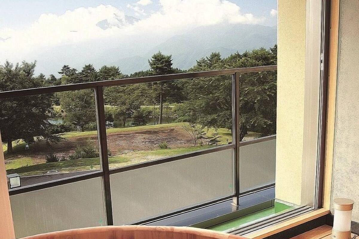 A hot tub with a view of a road and trees.