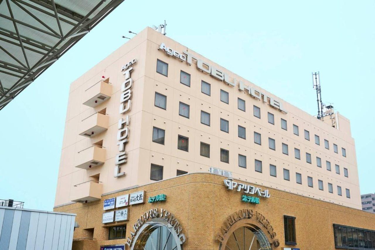 A multi-story hotel with a flat facade, multiple windows, and signage indicating it is a hotel.