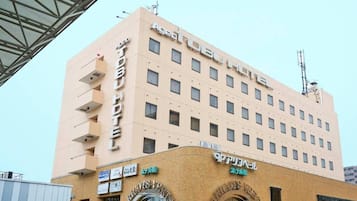 A multi-story hotel with a flat facade, multiple windows, and signage indicating it is a hotel.