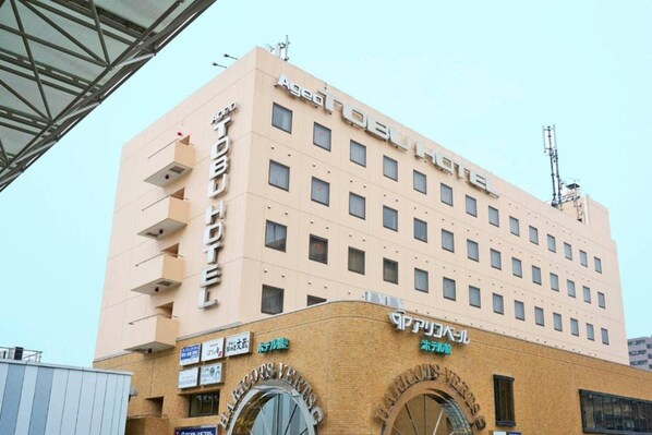 A multi-story hotel with a flat facade, multiple windows, and signage indicating it is a hotel. - Ageo Tobu Hotel (Ageo)
