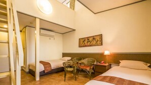A hotel room with two beds, a desk, a chair, a lamp, and a painting on the wall. - Casual Seagull (Nishiizu)
