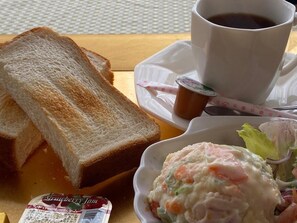 A meal consisting of toast, a cup of coffee, a bowl of salad, and a container of jam. - Atami Minoya Hotel (Atami)