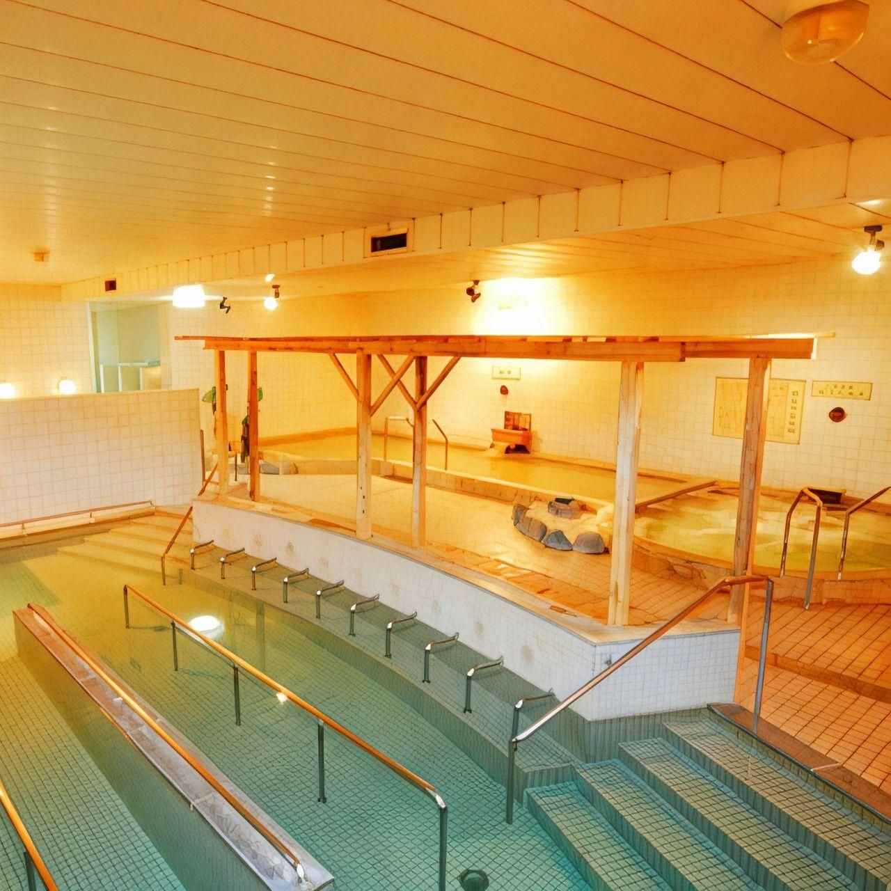 A traditional Japanese onsen with a wooden bathhouse, tiled walls, and a tiled floor.