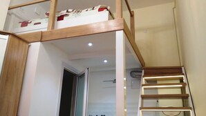 A bunk bed with a wooden frame and a white mattress with red accents. - Apartments 1 min to Opera House (Lviv)