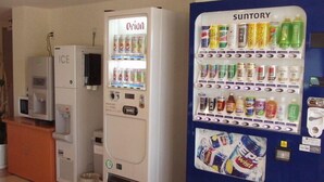 A vending machine with a variety of drinks and a microwave. - Hotel Joetsu Public City (Joetsu)